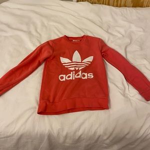 This is an Addias Sweatshirt and is peachy pink color and is very comfortable!